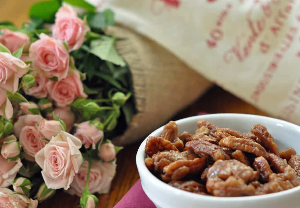 A white dish filled with homemade toffee pecans (caramelized pecans)