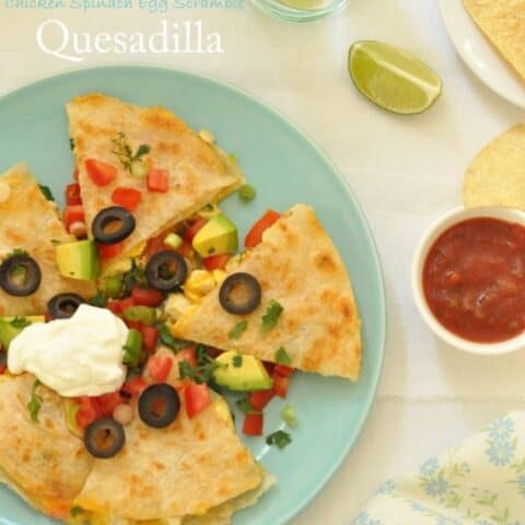 A green plate filled with a Breakfast Quesadilla cut into 5 wedges.
