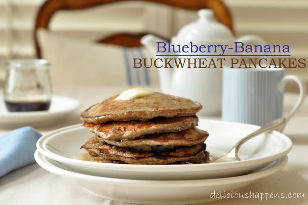 A white plate filled with a stack of Blueberry Banana Buckwheat Pancakes.