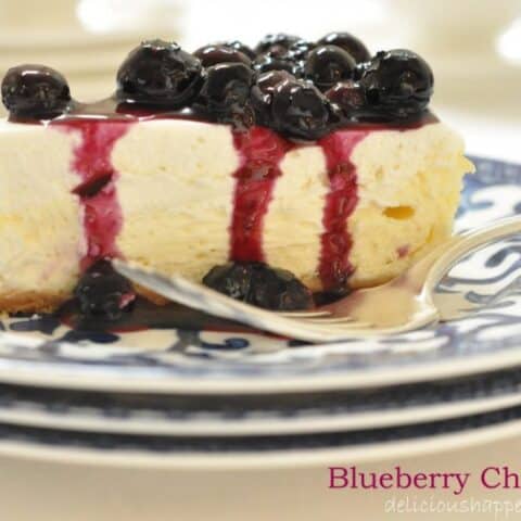 This two-layered Blueberry Cheesecake that's extra creamy with a delicate graham cracker crust and topped with a homemade blueberry sauce