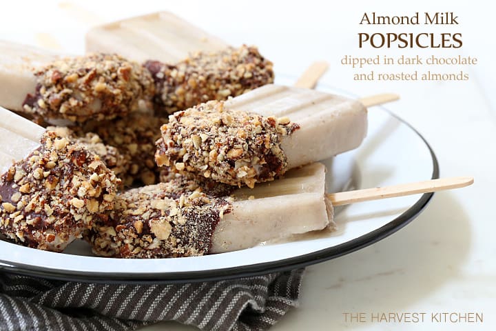 These Almond Milk Popsicle are made with almond milk, almond butter, bananas and Greek yogurt, then dipped in chocolate sauce and rolled in toasted almonds