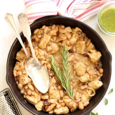 A cast iron pan filled with Tuscan Chicken Skillet.