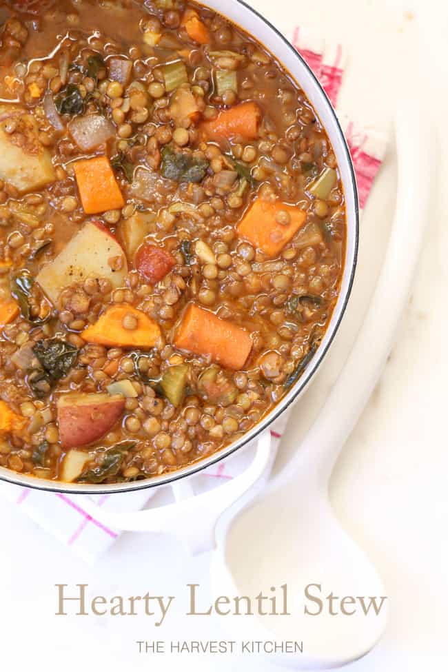 A white pot filled with legume and vegetables.