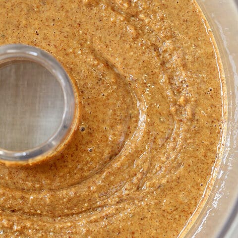A food processor filled with homemade almond butter