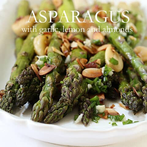 This Roasted Asparagus with Lemon and Garlic Delicious is garnished with roasted garlic cloves, minced garlic, lemon juice, toasted almonds and chives