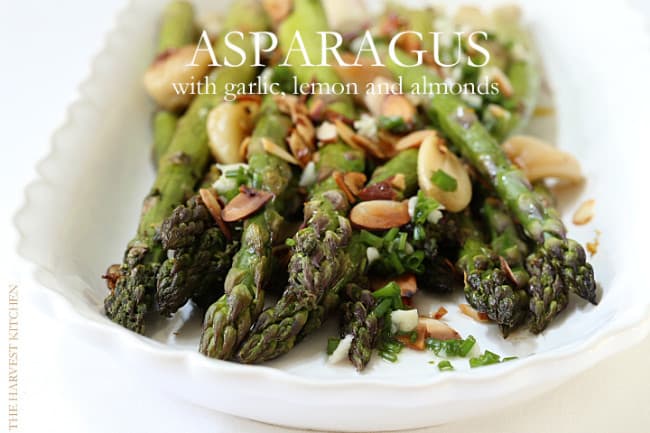 This Roasted Asparagus with Lemon and Garlic Delicious is garnished with roasted garlic cloves, minced garlic, lemon juice, toasted almonds and chives