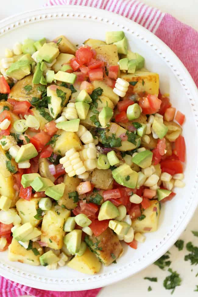 A white bowl filled with Mexican Potato Salad.