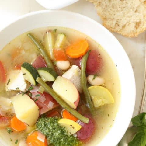 Soupe au pistou is a crowd-pleasing French vegetable soup loaded with zucchini, yellow squash and tomatoes, potatoes, beans, herbs and served with pesto