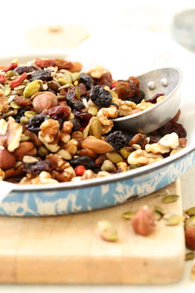 A round pie tin filled with nuts and dried fruit.