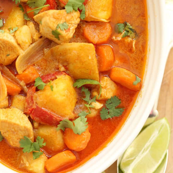 A white bowl filled with Thai Coconut Curry Chicken.