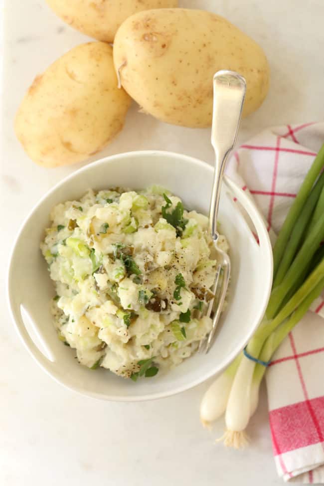 This creamy Dill Pickle Potato Salad is made with potatoes, celery, green onion, parsley and dill pickles all tossed in a light dressing