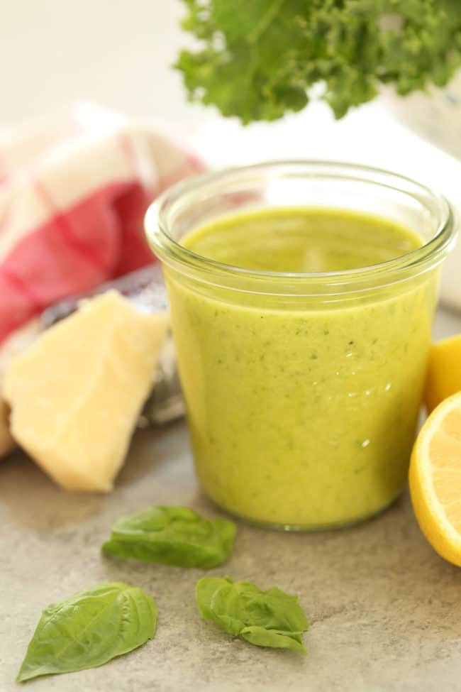 A glass jar of lemon basil vinaigrette.