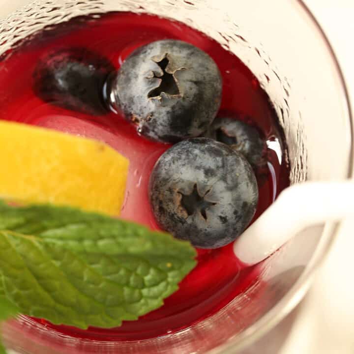 glass of immunity booster drink made of blueberries and green tea