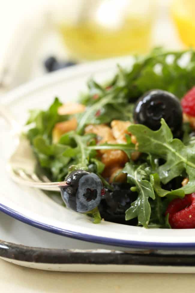 This Immune Boosting Arugula Berry Salad combines wild arugula with a mix of fresh sweet berries, apple and walnuts all tossed in a citrus vinaigrette