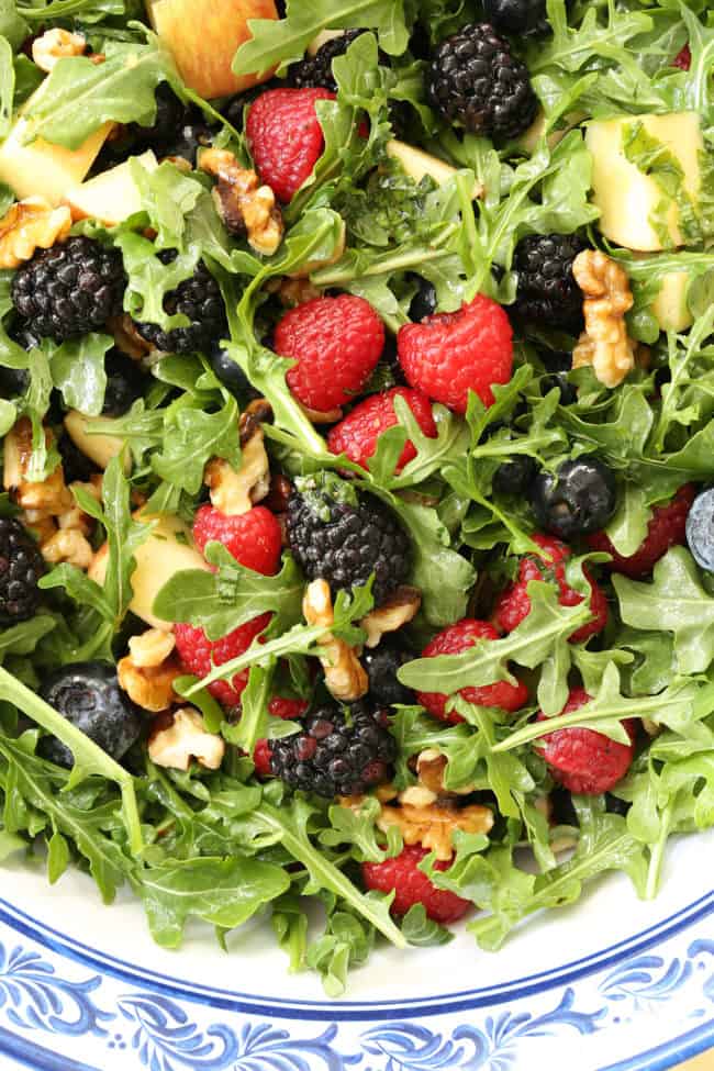 This Immune Boosting Arugula Berry Salad combines wild arugula with a mix of fresh sweet berries, apple and walnuts all tossed in a citrus vinaigrette