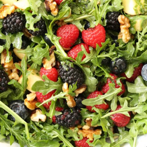 This Immune Boosting Arugula Berry Salad combines wild arugula with a mix of fresh sweet berries, apple and walnuts all tossed in a citrus vinaigrette