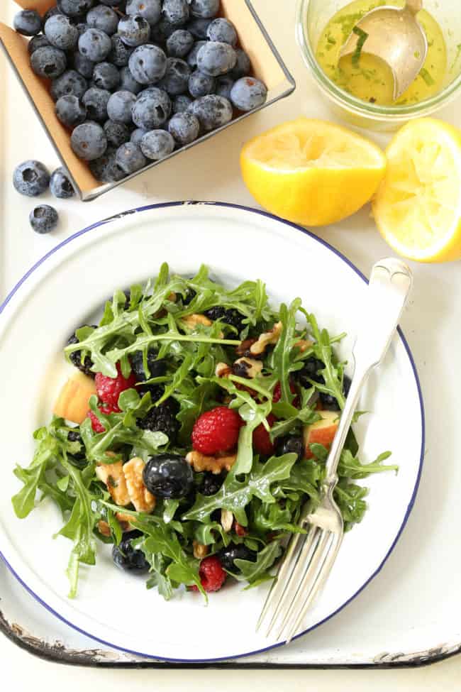 This Immune Boosting Arugula Berry Salad combines wild arugula with a mix of fresh sweet berries, apple and walnuts all tossed in a citrus vinaigrette