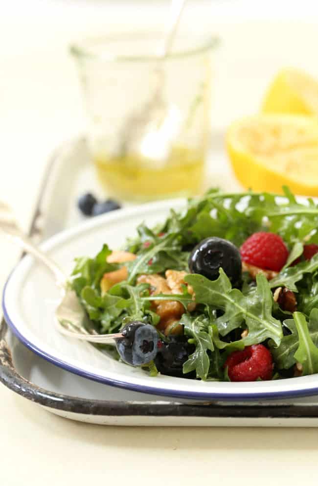 This Immune Boosting Arugula Berry Salad combines wild arugula with a mix of fresh sweet berries, apple and walnuts all tossed in a citrus vinaigrette