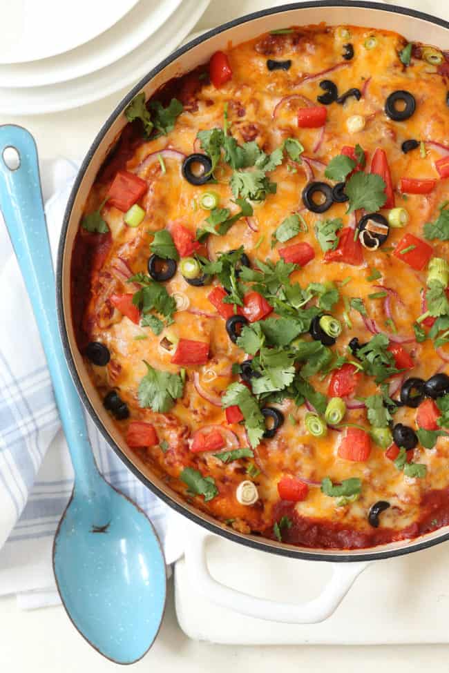 A white pot filled with a cheesy stew.