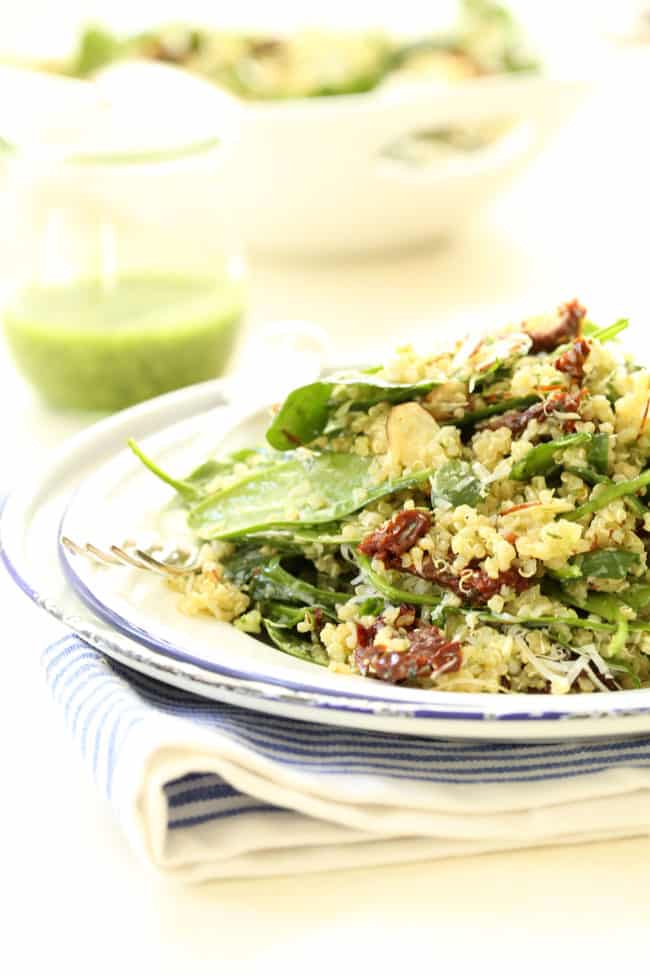 A plate of spinach and quinoa salad.