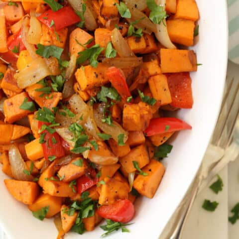 An oval platter filled with breakfast sweet potatoes.