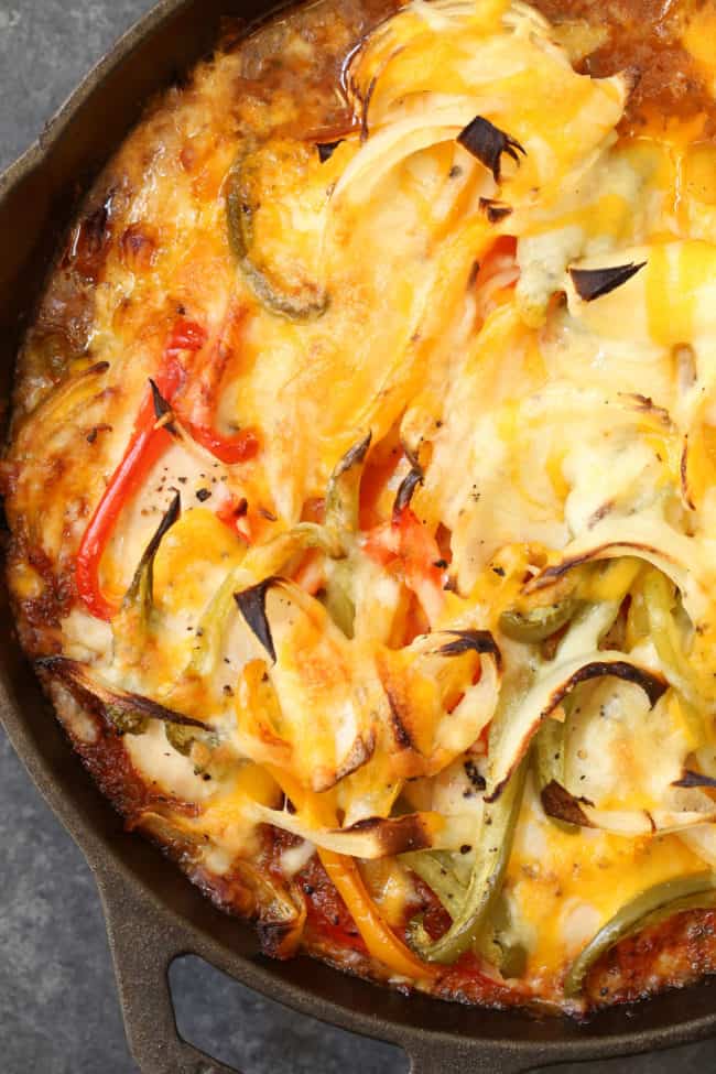 A black skillet filled with a chicken fajita bake dish.