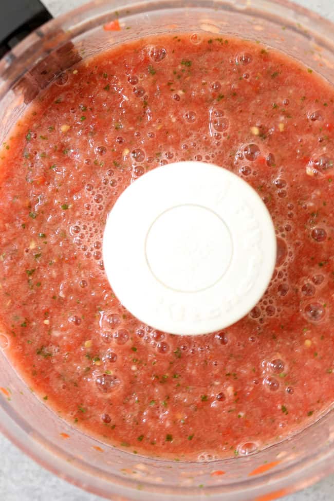 A food processor filled with salsa.