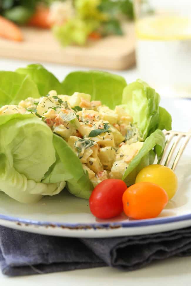 Healthy Egg Salad on lettuce leaves.