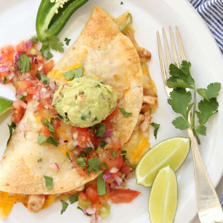 A baked chicken fajita quesadilla on a white plate.