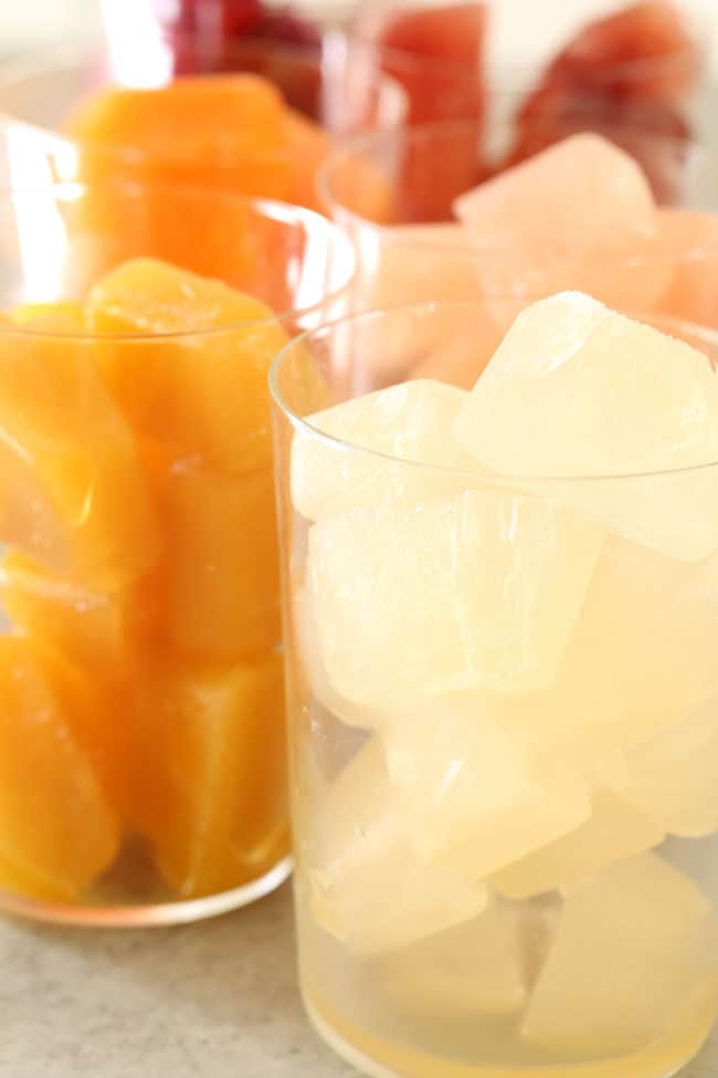 glasses filled with fruit juice ice cubes