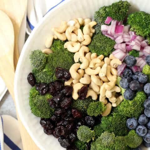 A white bowl filled with broccoli salad.