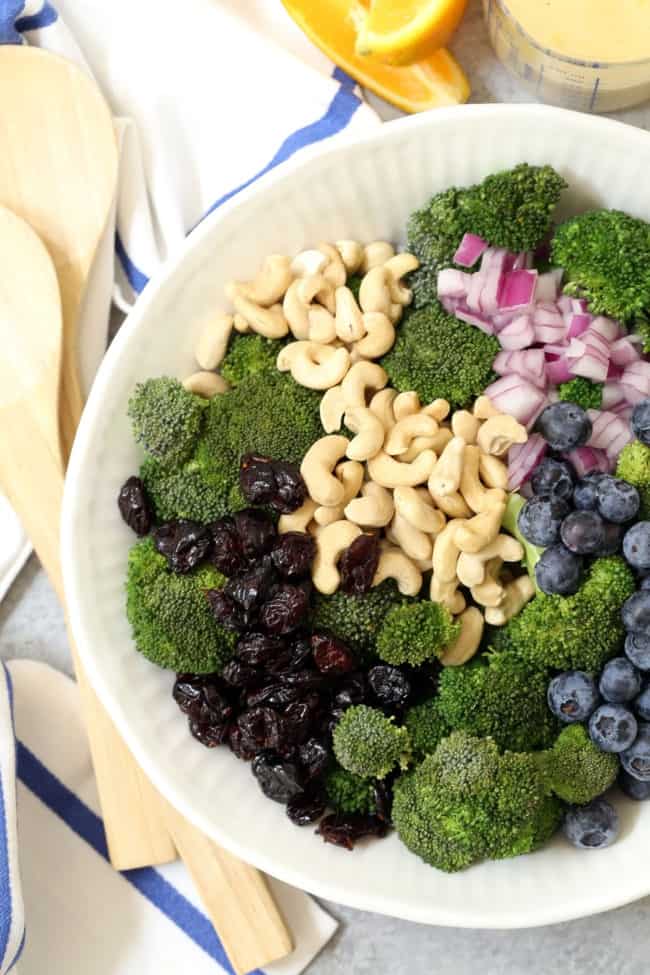 A white bowl filled with chopped broccoli salad.