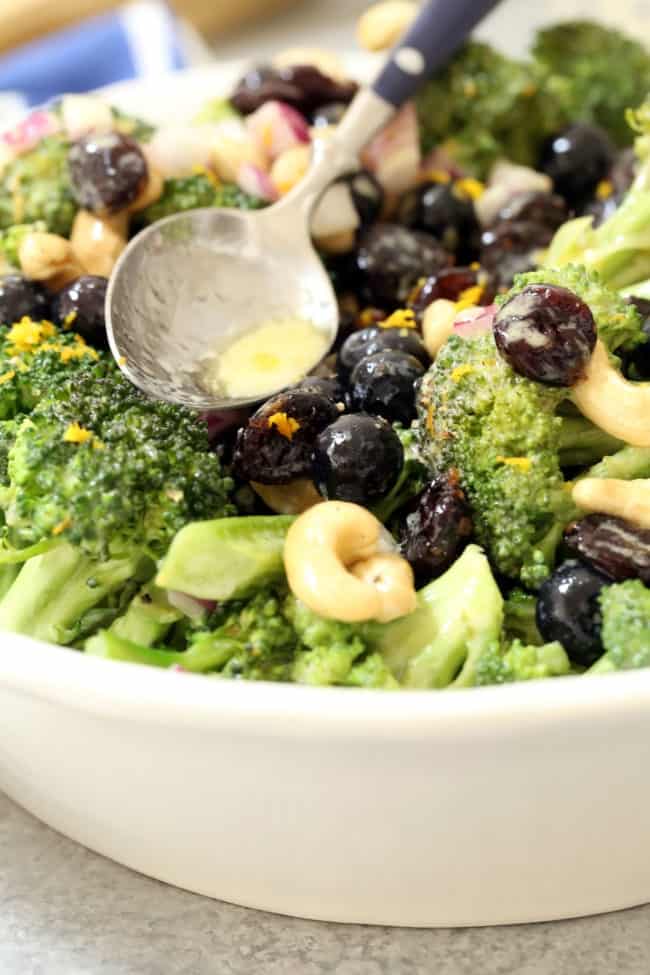 Broccoli Detox Salad is crisp and crunchy and loaded with broccoli, blueberries, cranberries and onion all tossed in a delicious light orange dressing