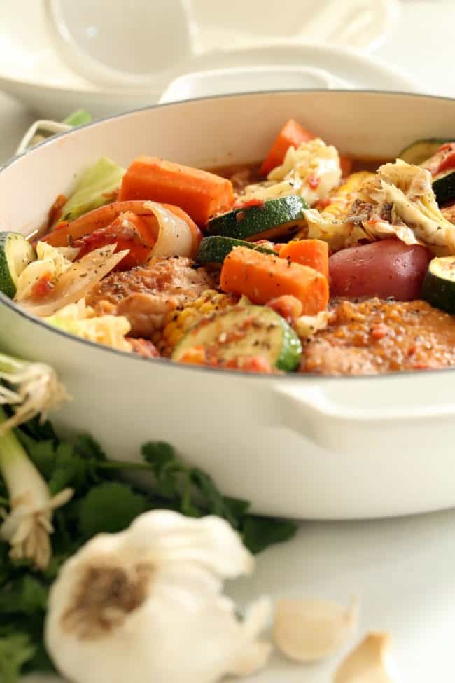 white pot with chicken and vegetable stew