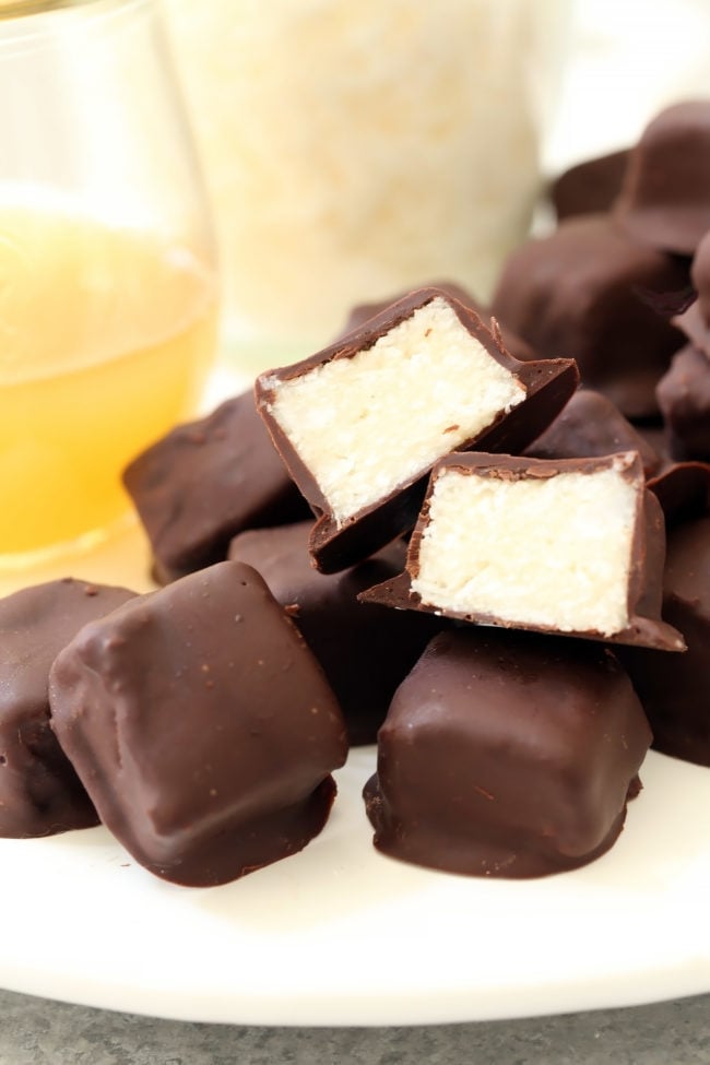 A white plate filled with small chocolate coconut bites.