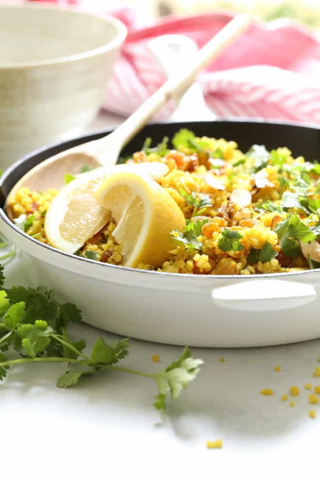 A white skilled filled with lemon quinoa.
