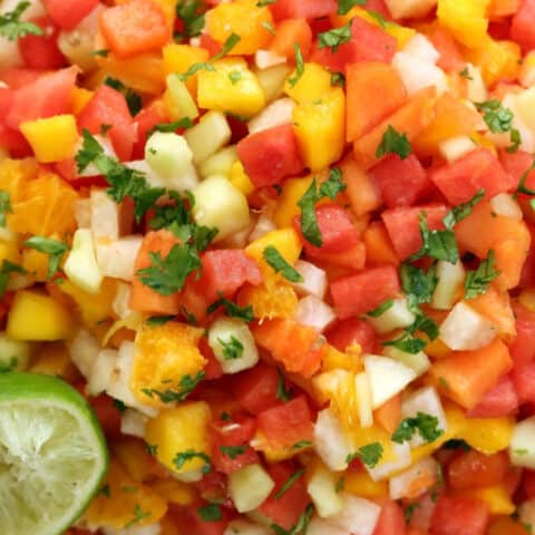 This Mexican Gazpacho Fruit Salad is a combination of watermelon, papaya, mango, jicama, cucumber and orange, and it's tossed in lime juice and sprinkled with chili powder