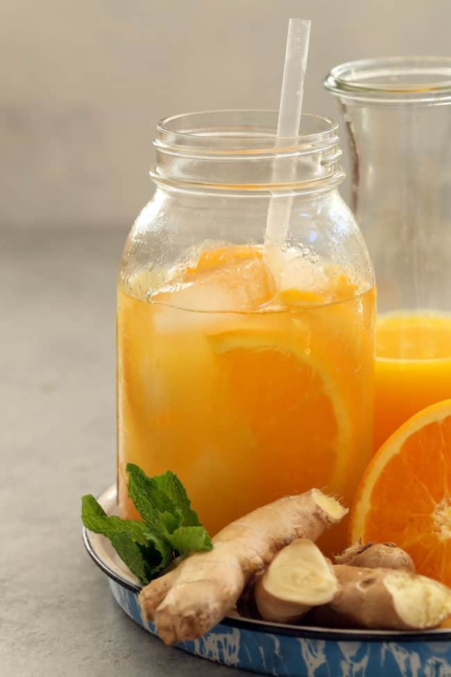 Mason jar filled with orange ginger green tea.