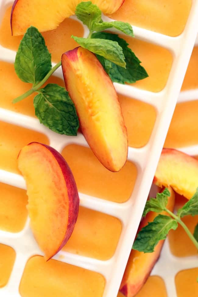 These Summer Peach Ice Cubes are made with peach puree and will transform a tall glass of water or your favorite iced tea into a delicious summer drink