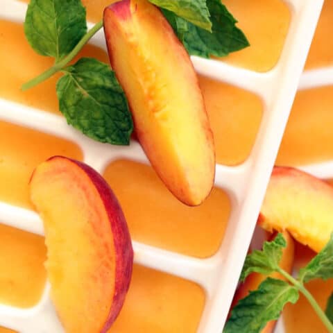 These Summer Peach Ice Cubes are made with peach puree and will transform a tall glass of water or your favorite iced tea into a delicious summer drink