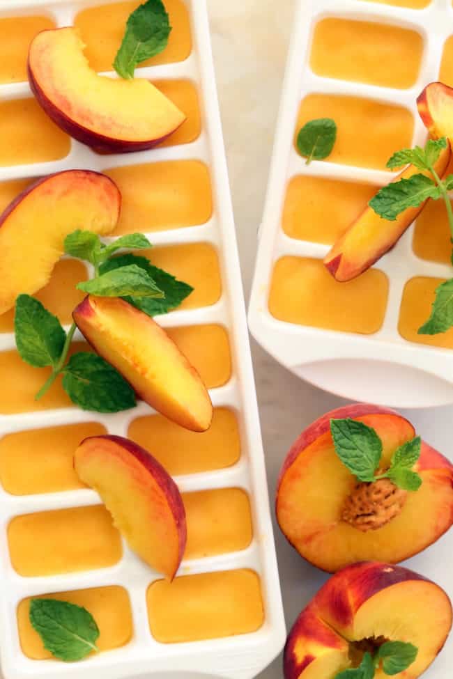 These Summer Peach Ice Cubes are made with peach puree and will transform a tall glass of water or your favorite iced tea into a delicious summer drink