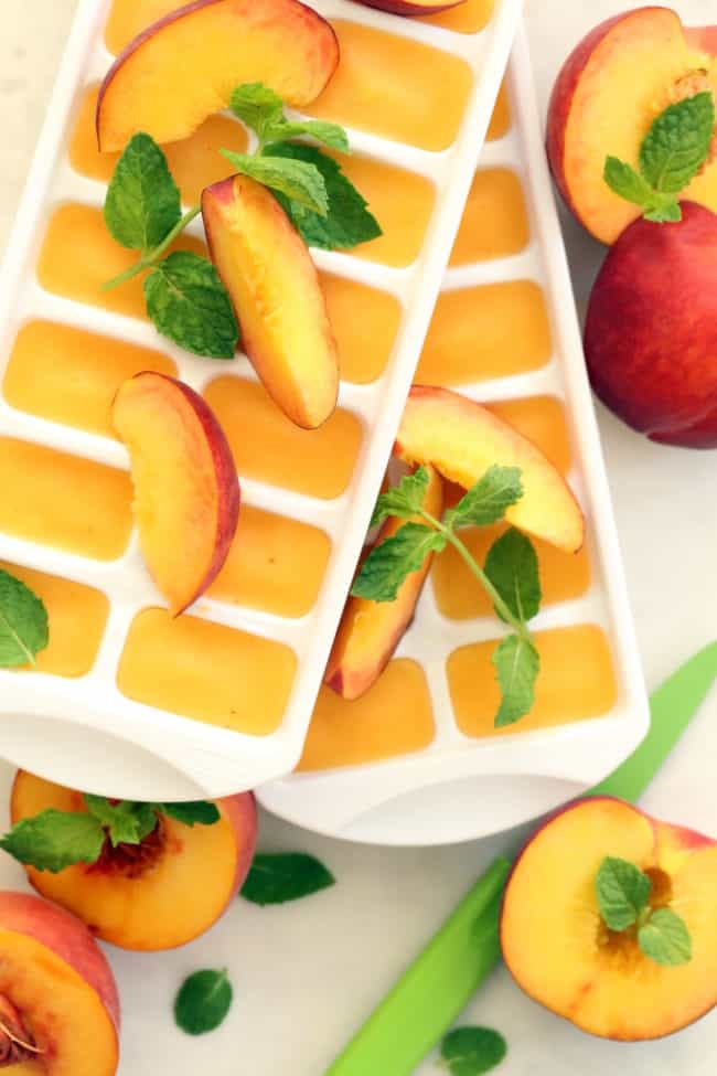 These Summer Peach Ice Cubes are made with peach puree and will transform a tall glass of water or your favorite iced tea into a delicious summer drink