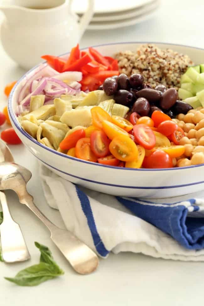 A large white bowl filled with chopped vegetables and chickpeas.