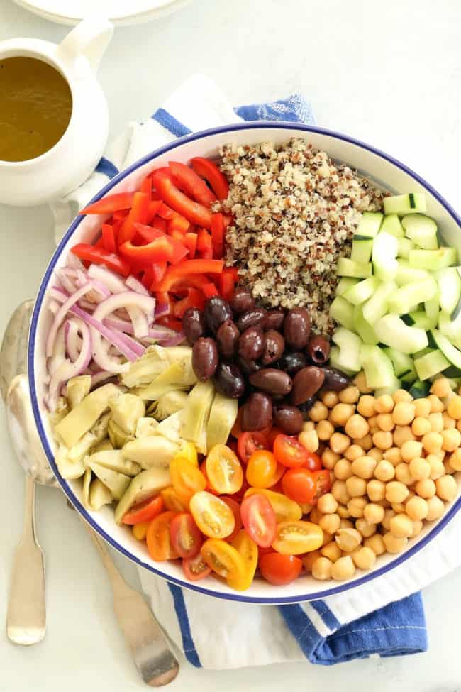 A large white bowl filled with chopped vegetables and chickpeas.