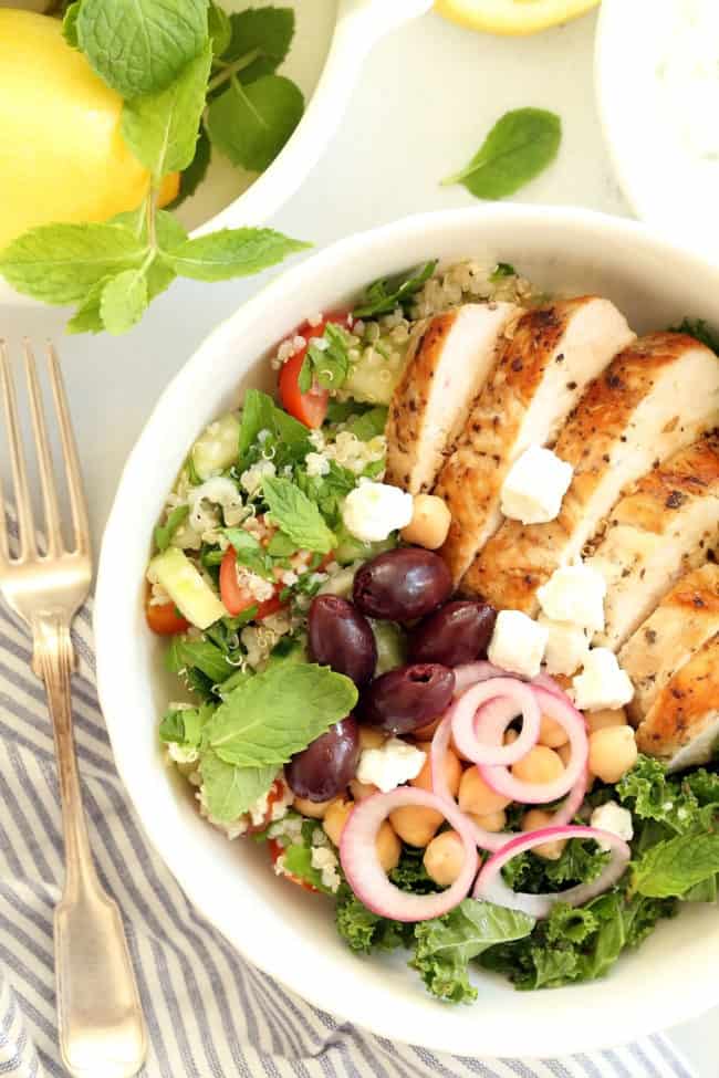 A white bowl of cooked chicken and vegetables