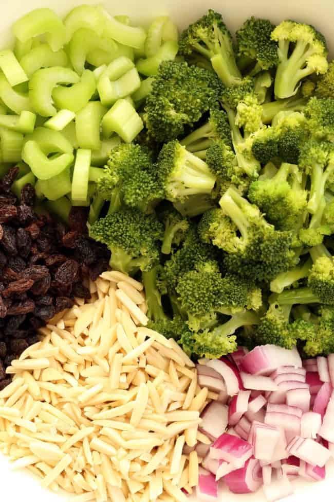 bowl of ingredients for broccoli and raisin salad