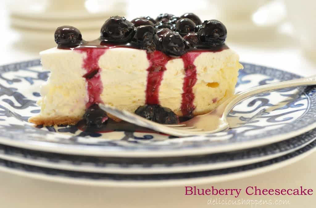 This two-layered Blueberry Cheesecake that's extra creamy with a delicate graham cracker crust and topped with a homemade blueberry sauce