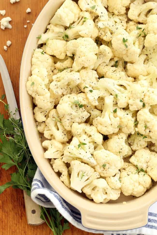 A white baking dish filled with cruciferous vegetables. 