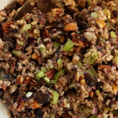 A white bowl filled with wild rice salad.