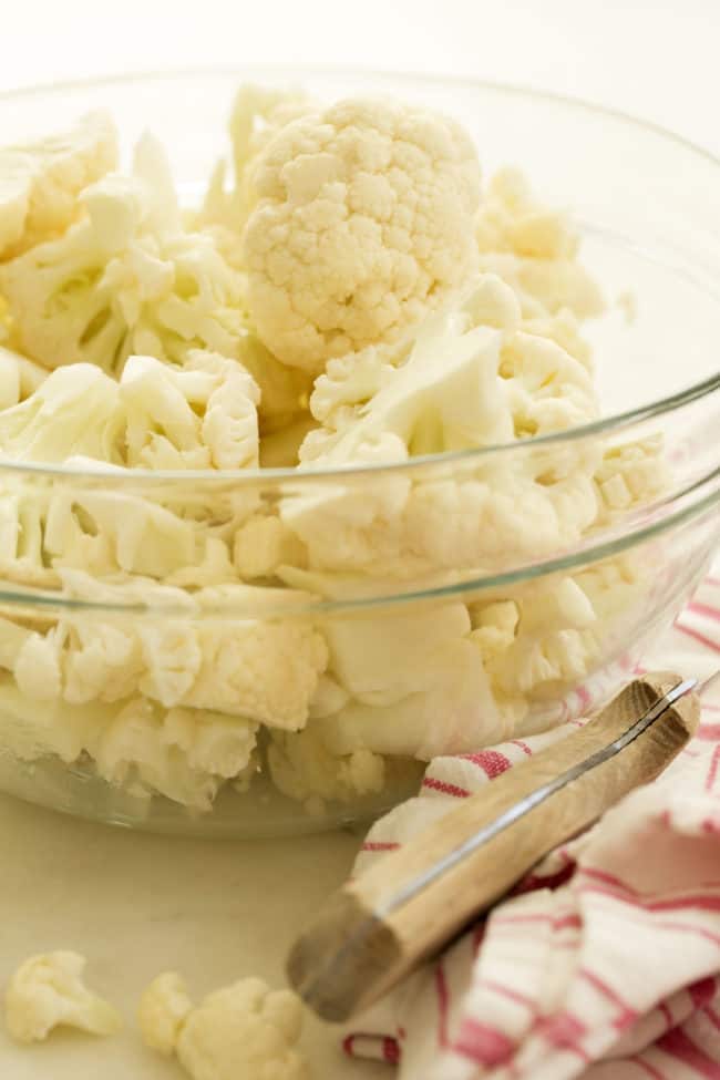 A clear glass bowl filled with chopped vegetables.